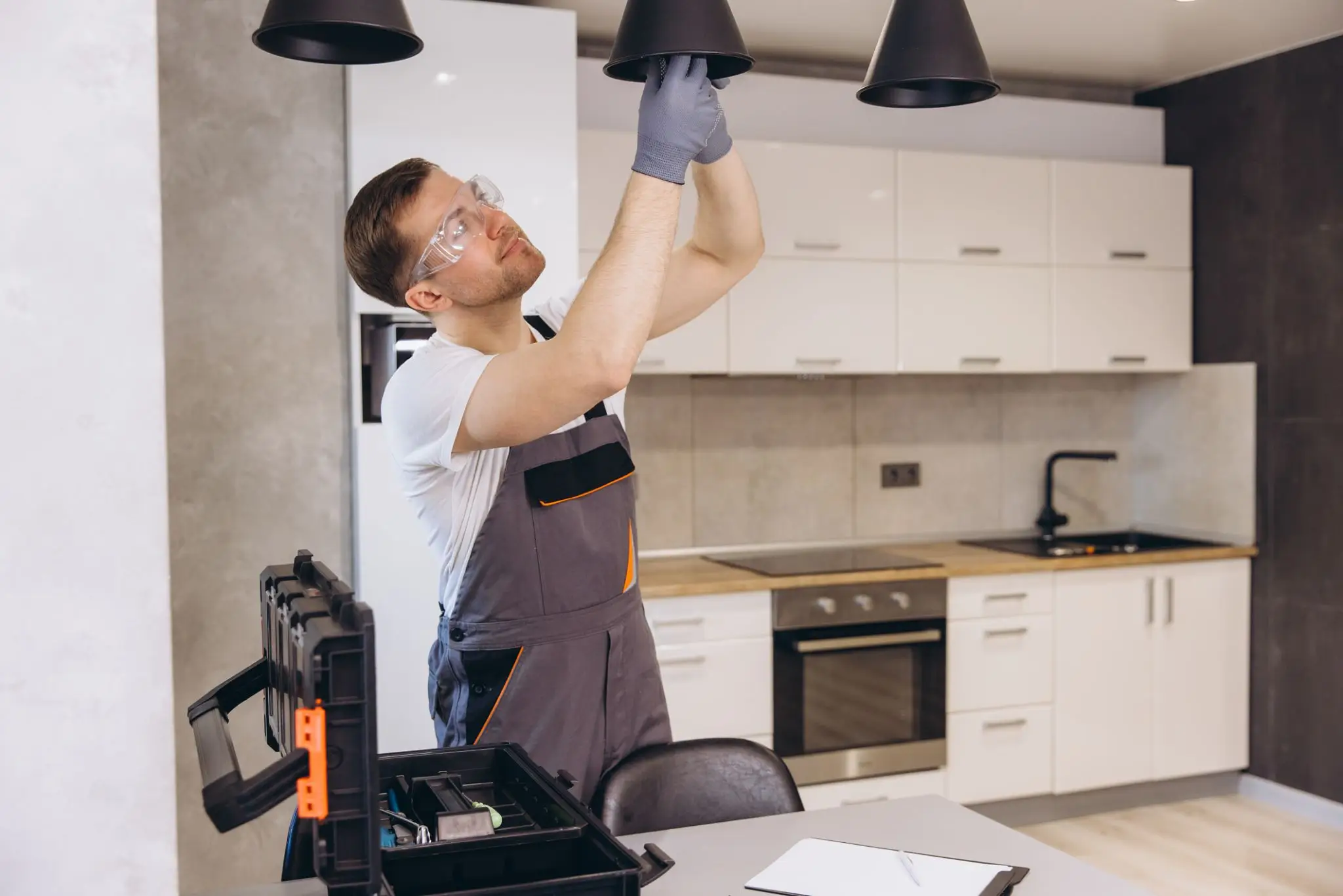 Technician working on kitchen lighting setup