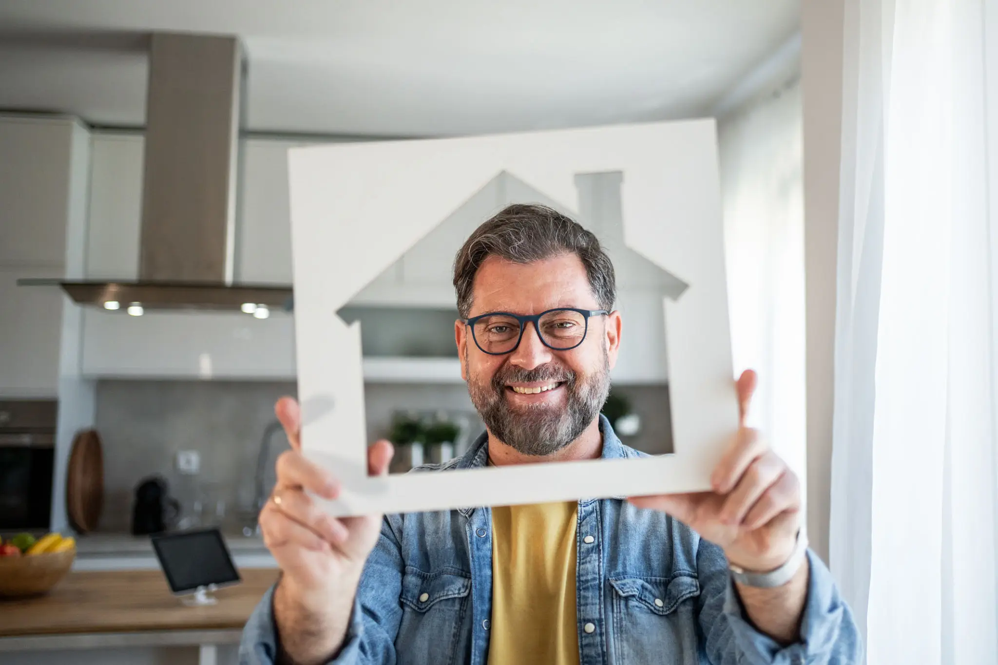 Man holding house-shaped cutout